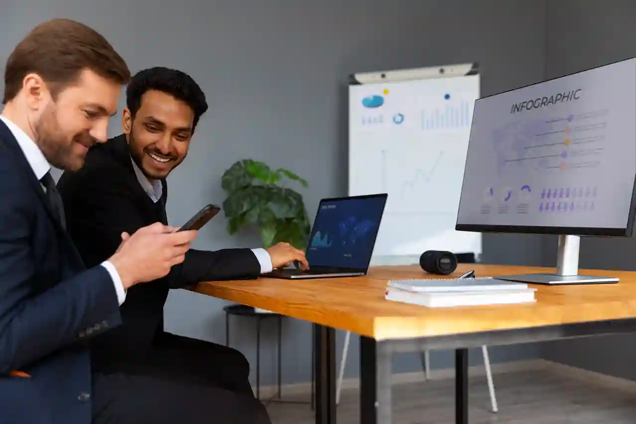Workspace with charts, notes, and a laptop used for developing a detailed research project proposal.